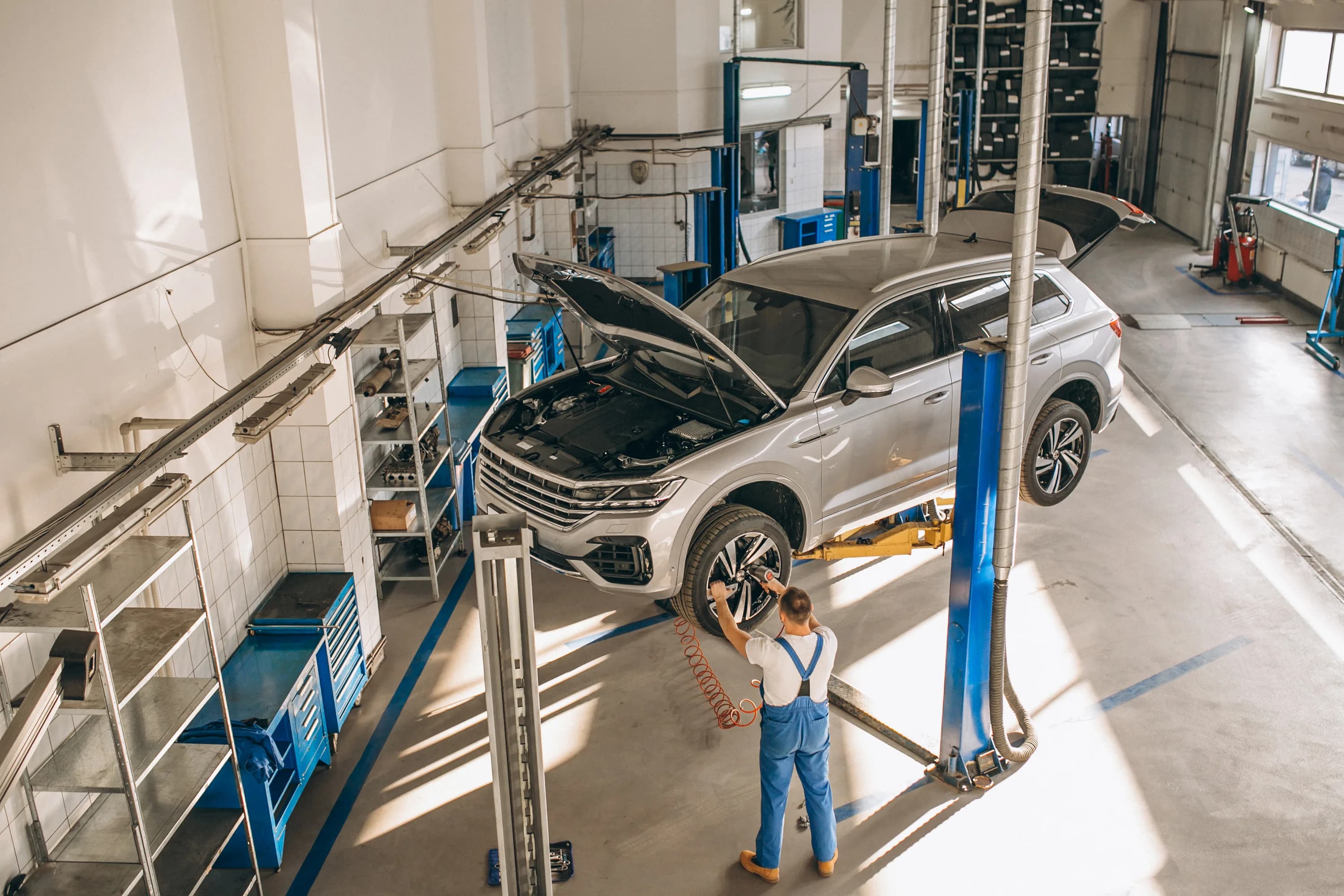 Mechanic checking a car for diagnostics at Cali Auto Shop